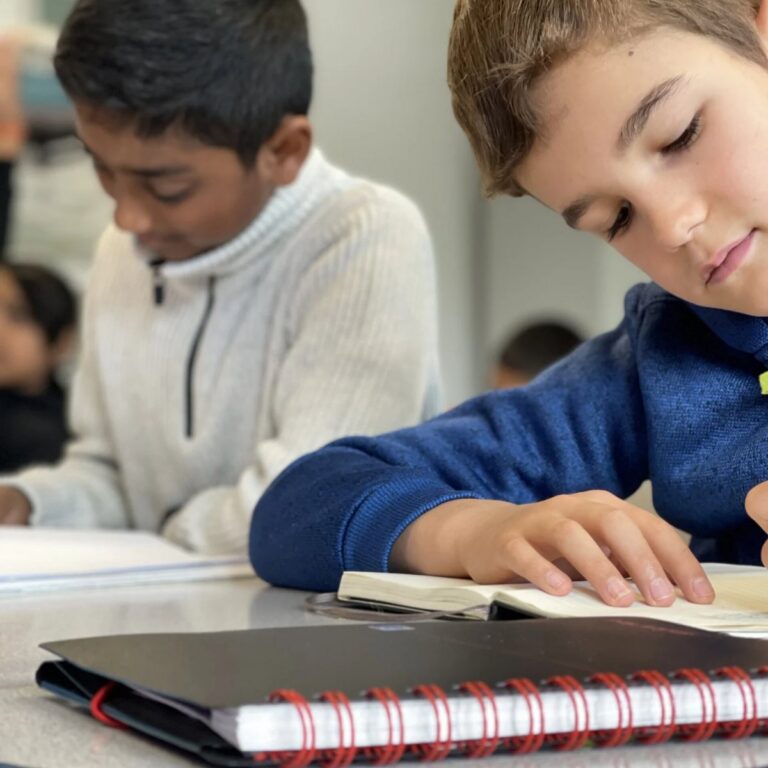 Two boys writing answers in a Pillai Tutors class